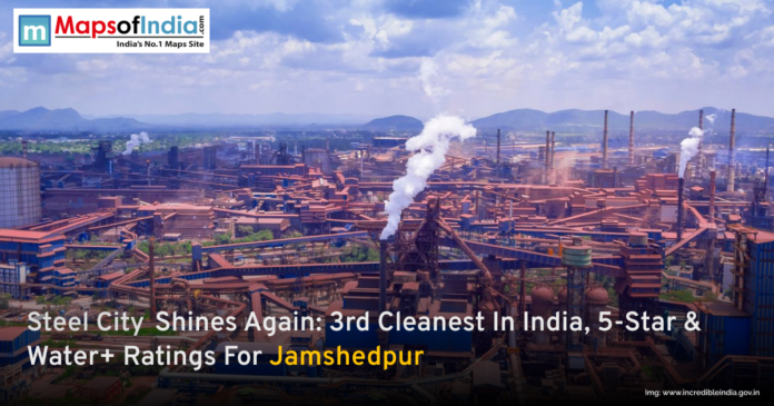 A panoramic view of the Jamshedpur industrial landscape with smoke rising from steel plants, highlighting the city's achievement as the 3rd cleanest in India with 5-Star and Water+ ratings