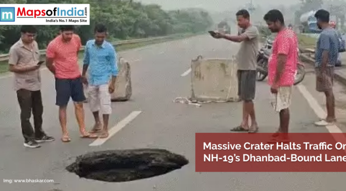 Massive Crater Halts Traffic on NH-19’s Dhanbad-Bound Lane People gather around a large crater that has formed on NH-19's Dhanbad-bound lane, causing a traffic halt; concrete barriers are placed nearby for safety.