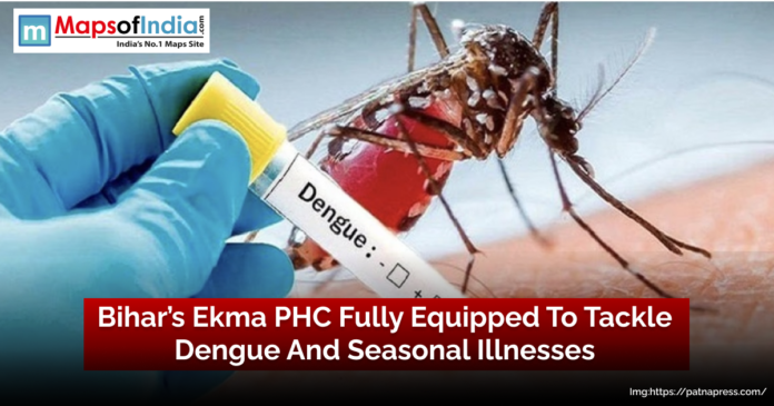 Close-up of a mosquito biting human skin with a gloved hand holding a test tube labeled “Dengue,” overlaid with the headline “Bihar’s Ekma PHC Fully Equipped To Tackle Dengue And Seasonal Illnesses”