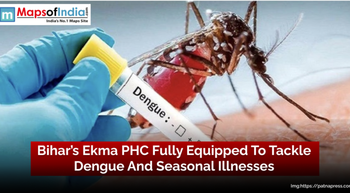 Bihar’s Ekma PHC Fully Equipped to Tackle Dengue and Seasonal Illnesses Close-up of a mosquito biting human skin with a gloved hand holding a test tube labeled “Dengue,” overlaid with the headline “Bihar’s Ekma PHC Fully Equipped To Tackle Dengue And Seasonal Illnesses”
