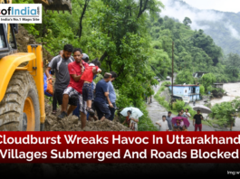 Flooded villages and blocked roads in Uttarakhand after a devastating cloudburst, with houses submerged and transport disrupted.
