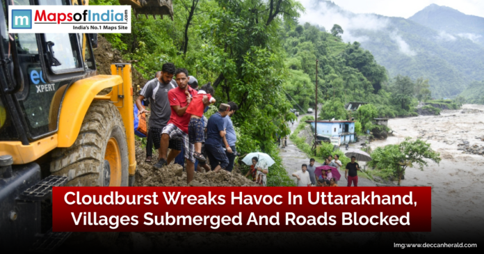 Flooded villages and blocked roads in Uttarakhand after a devastating cloudburst, with houses submerged and transport disrupted.