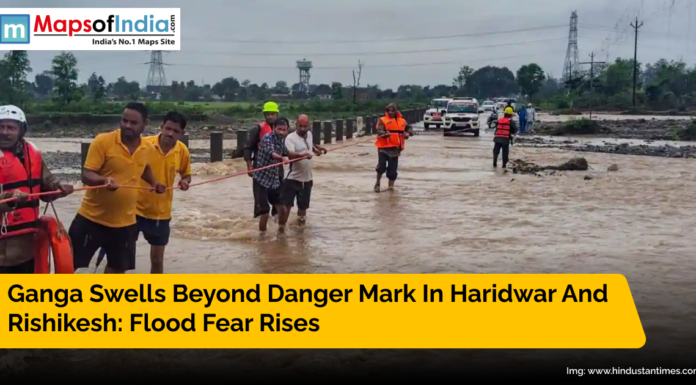 Ganga Swells Beyond Danger Mark in Haridwar and Rishikesh: Flood Fear Rises Rescue teams help stranded people cross flooded streets as the Ganga river rises beyond danger mark in Haridwar and Rishikesh after heavy rains.