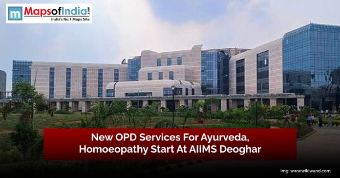 A modern multi-story hospital building with large glass windows and a landscaped garden in front. Overlay text in a red banner reads, 