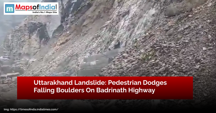 Uttarakhand landslide on Badrinath Highway showing debris and falling boulders as a pedestrian narrowly escapes danger.