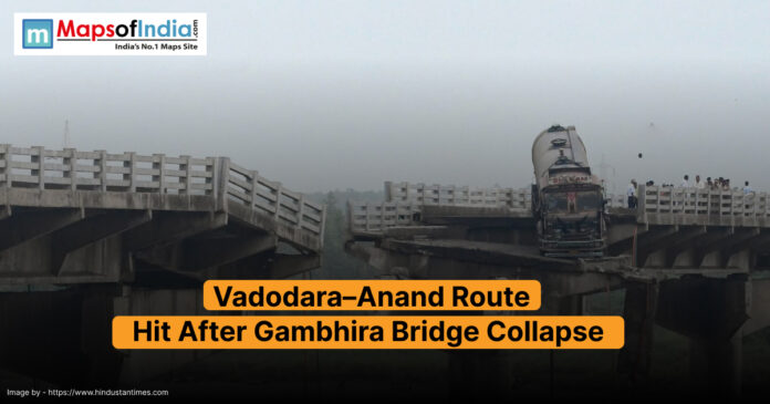 Collapsed section of the Gambhira Bridge on the Vadodara–Anand route, with a truck stranded on the broken edge and people gathered at the site.