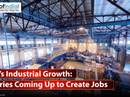 A wide-angle, interior shot of a large, modern factory floor. The space is filled with industrial machinery, pipes, conveyor belts, and other equipment.