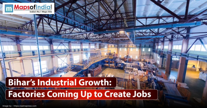 A wide-angle, interior shot of a large, modern factory floor. The space is filled with industrial machinery, pipes, conveyor belts, and other equipment.