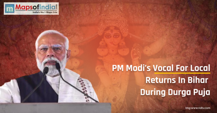 PM Narendra Modi addressing the public with an image of Goddess Durga in the background, highlighting the return of Vocal for Local campaign in Bihar during Durga Puja.