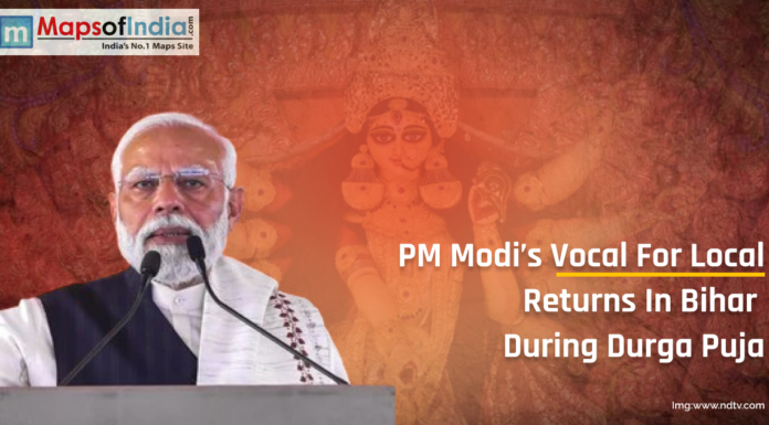 PM Modi’s Vocal for Local Returns in Bihar During Durga Puja PM Narendra Modi addressing the public with an image of Goddess Durga in the background, highlighting the return of Vocal for Local campaign in Bihar during Durga Puja.