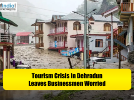 Flooded street scene in Dehradun with damaged buildings and vehicles, conveying a tourism crisis that has left local businessmen worried.