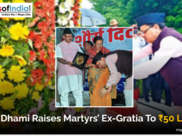 Image showing Uttarakhand Chief Minister Pushkar Singh Dhami honoring the family of a martyr during an event. The text on the image reads “CM Dhami Raises Martyrs’ Ex-Gratia To ₹50 Lakh.” The background includes flowers and the Maps of India logo.