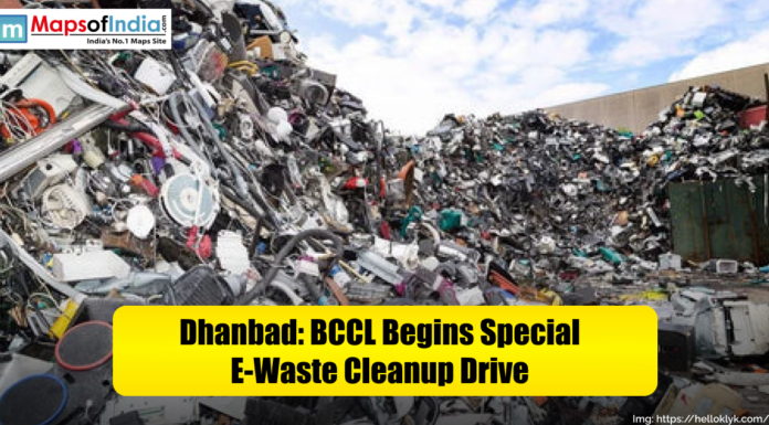 Dhanbad: BCCL Begins Special E-Waste Cleanup Drive A large pile of discarded electronic waste including cables, wires, and old appliances is shown in Dhanbad. The image highlights a cleanup drive launched by BCCL to manage and recycle e-waste, with a Maps of India logo and the caption “Dhanbad: BCCL Begins Special E-Waste Cleanup Drive” displayed on a yellow banner.