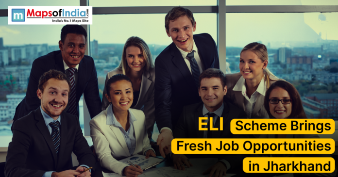 ELI Scheme Brings A group of young professionals in formal attire smiling and posing together in an office setting with a cityscape in the background. The image includes the text “ELI Scheme Brings Fresh Job Opportunities in Jharkhand” along with the Maps of India logo.