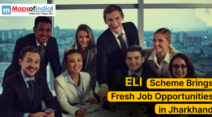 ELI Scheme Brings Fresh Job Opportunities in Jharkhand A group of young professionals in formal attire smiling and posing together in an office setting with a cityscape in the background. The image includes the text “ELI Scheme Brings Fresh Job Opportunities in Jharkhand” along with the Maps of India logo.
