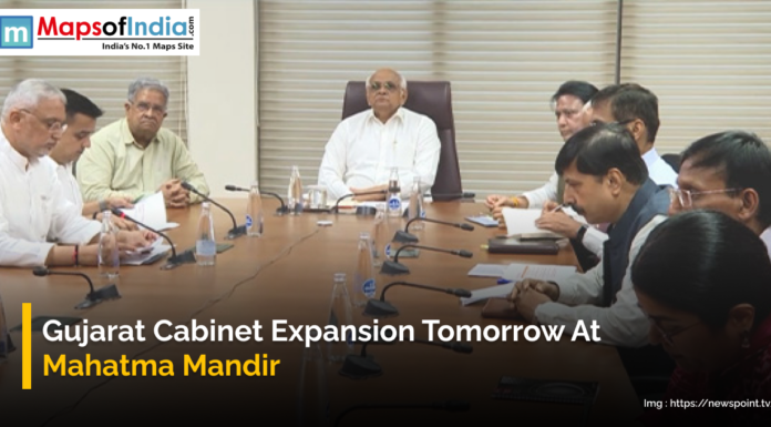 Gujarat Cabinet Expansion Tomorrow at Mahatma Mandir A group of officials is seated around a conference table at a formal meeting, with the text "Gujarat Cabinet Expansion Tomorrow At Mahatma Mandir" displayed at the bottom.