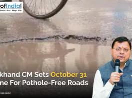 Uttarakhand CM Pushkar Singh Dhami and in background, a road with potholes