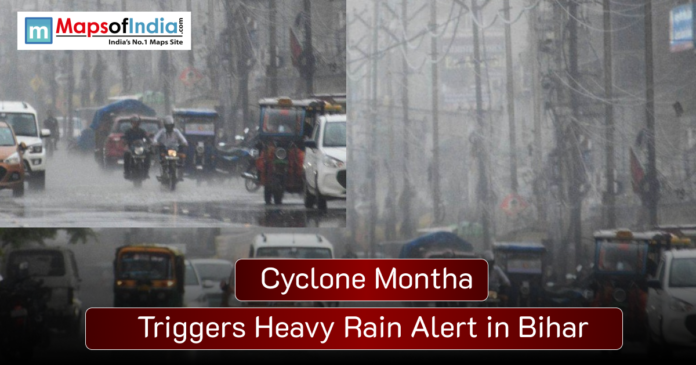 cyclone montha Vehicles and people move through heavy rainfall on a city street in Bihar, with poor visibility due to Cyclone Montha, as the image headline reads “Cyclone Montha Triggers Heavy Rain Alert in Bihar”
