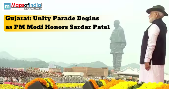 gujarat (4) Prime Minister Narendra Modi stands before the Statue of Unity in Gujarat during the Unity Parade, honoring Sardar Vallabhbhai Patel amidst floral decorations.