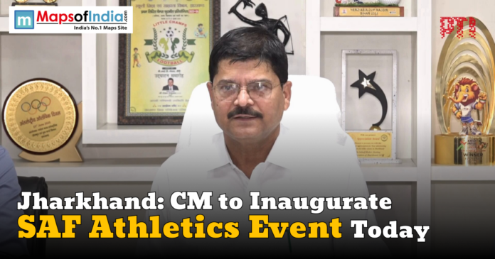 A man sitting in a white chair in front of a shelf with trophies and awards, with text overlay stating 'Jharkhand: CM to Inaugurate SAF Athletics Event Today' and a Maps of India logo in the top left corner.