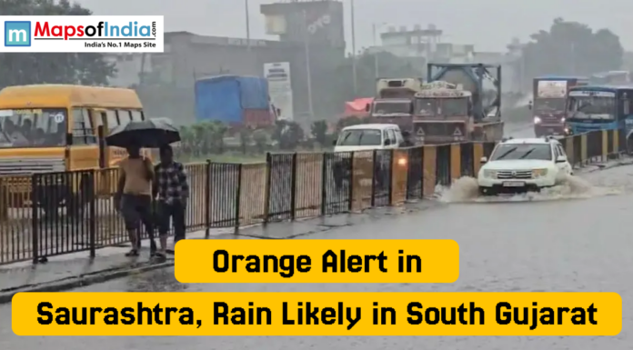 Orange Alert in Saurashtra, Rain Likely in South Gujarat Vehicles move slowly through a waterlogged road as people walk under umbrellas during heavy rain in Gujarat, with the headline “Orange Alert in Saurashtra, Rain Likely in South Gujarat”