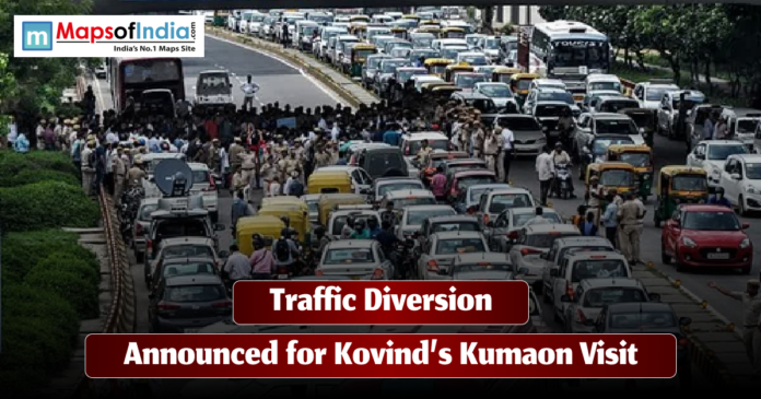 traffic A busy road filled with cars, auto-rickshaws, and people as police officers manage traffic during a diversion. The image includes the text “Traffic Diversion Announced for Kovind’s Kumaon Visit” along with the Maps of India logo