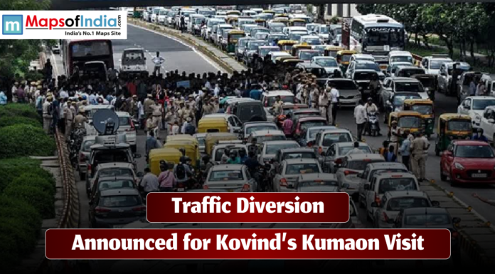 Traffic Diversion Announced for Kovind’s Kumaon Visit A busy road filled with cars, auto-rickshaws, and people as police officers manage traffic during a diversion. The image includes the text “Traffic Diversion Announced for Kovind’s Kumaon Visit” along with the Maps of India logo