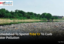 Ahmedabad to Spend ₹160 Cr to Curb Water Pollution A polluted river in Ahmedabad filled with waste, with trees and buildings visible in the background.