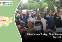 Bihar Votes Today: Final Phase Polls for 122 Seats Voters in Bihar stand in line showing their ID cards as they participate in the final phase of polling for 122 assembly seats during the state elections.