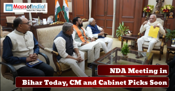 NDA Meeting A group of political leaders seated in a meeting room discussing government matters, with Indian flags in the background and text reading “NDA Meeting in Bihar Today, CM and Cabinet Picks Soon.”