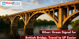 Bihar: Green Signal for Bettiah Bridge, Travel to UP Easier A low-angle photo of a concrete arch bridge (the Bettiah Bridge) spanning a river under a sunset sky, with the text "Bihar: Green Signal for Bettiah Bridge, Travel to UP Easier."