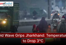 Cold Wave Grips Jharkhand: Temperatures to Drop 3°C People wrapped in blankets gather around a small fire on a foggy street in Jharkhand as temperatures drop during a severe cold wave, with vehicles passing nearby.