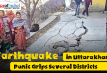 Earthquake in Uttarakhand: Panic Grips Several Districts People stand near a cracked and damaged road after an earthquake in Uttarakhand, showing visible destruction and concern among residents in affected districts.