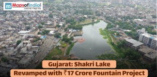 Gujarat: Shakri Lake Revamped with ₹17 Crore Fountain Project Aerial view of Shakri Lake in an urban area of Gujarat, with text announcing its revamp with a ₹17 Crore fountain project.