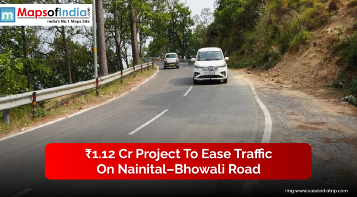 ₹1.12 Cr Project to Ease Traffic on Nainital–Bhowali Road A view of vehicles driving along the curved Nainital–Bhowali road surrounded by trees, highlighting the ₹1.12 crore project aimed at easing traffic in the hilly region.