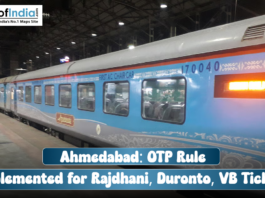 Ahmedabad: OTP Rule Implemented for Rajdhani, Duronto, VB Tickets A blue and grey train (Rajdhani Express) car at a station platform, with a text overlay reading: "Ahmedabad: OTP Rule Implemented for Rajdhani, Duronto, VB Tickets".