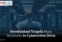 Ahmedabad Targets Mule Accounts in Cybercrime Drive A person sits at a desk in a dimly lit room surrounded by large computer monitors displaying data and code, representing cybersecurity operations. A headline overlay mentions Ahmedabad’s action against mule accounts in a cybercrime drive.