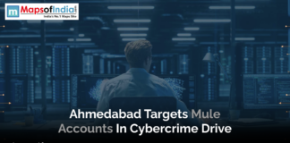Ahmedabad Targets Mule Accounts in Cybercrime Drive A person sits at a desk in a dimly lit room surrounded by large computer monitors displaying data and code, representing cybersecurity operations. A headline overlay mentions Ahmedabad’s action against mule accounts in a cybercrime drive.