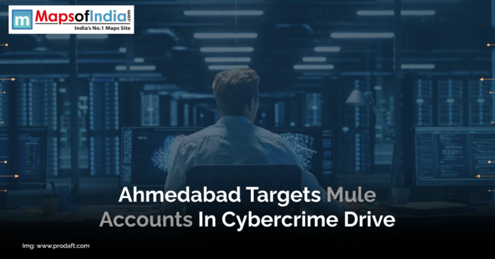 Ahmedabad Targets Mule Accounts in Cybercrime Drive A person sits at a desk in a dimly lit room surrounded by large computer monitors displaying data and code, representing cybersecurity operations. A headline overlay mentions Ahmedabad’s action against mule accounts in a cybercrime drive.