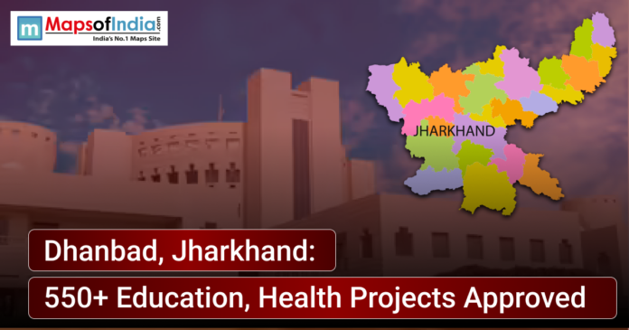 News graphic showing Dhanbad, Jharkhand, with a district map of Jharkhand highlighted and text announcing approval of 550+ education and health projects, alongside a government building in the background.