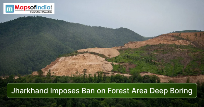 Forested hills in Jharkhand with a large deforested slope and excavation area, showing environmental impact alongside the headline “Jharkhand Imposes Ban on Forest Area Deep Boring” and Maps of India logo.