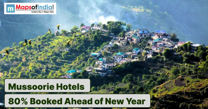 Hilltop view of Mussoorie town with hotels amid lush green mountains.