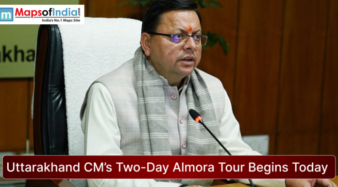 Uttarakhand CM’s Two-Day Almora Tour Begins Today Uttarakhand Chief Minister seated at a desk during an official meeting, speaking into a microphone, with the headline “Uttarakhand CM’s Two-Day Almora Tour Begins Today” and Maps of India logo displayed.