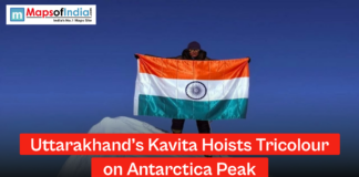 Uttarakhand’s Kavita Hoists Tricolour on Antarctica Peak A woman standing on a snowy Antarctic peak holding the Indian national flag, with a headline reading “Uttarakhand’s Kavita Hoists Tricolour on Antarctica Peak” and Maps of India logo.