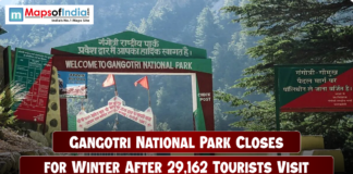 Gangotri National Park Closes for Winter After 29,162 Tourists Visit Entrance gate of Gangotri National Park surrounded by dense green forests and mountains, with a headline overlay stating “Gangotri National Park Closes for Winter After 29,162 Tourists Visit,” and the Maps of India logo at the top left corner.