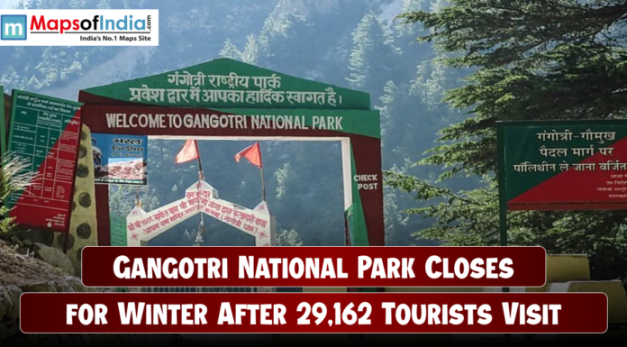 Gangotri National Park Closes for Winter After 29,162 Tourists Visit Entrance gate of Gangotri National Park surrounded by dense green forests and mountains, with a headline overlay stating “Gangotri National Park Closes for Winter After 29,162 Tourists Visit,” and the Maps of India logo at the top left corner.