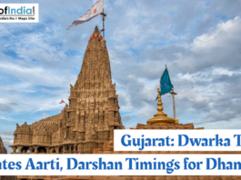 Dwarka Temple in Gujarat with its towering shikhara and flags fluttering, highlighting updated Aarti and Darshan timings for the Dhanurmas period.