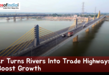 Bihar Turns Rivers Into Trade Highways to Boost Growth Aerial view of a modern cable-stayed bridge spanning a wide river in Bihar, with trucks and vehicles crossing, showcasing waterways and infrastructure development aimed at boosting trade and economic growth.