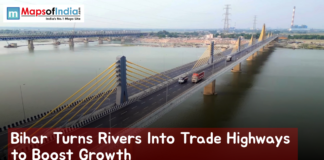 Bihar Turns Rivers Into Trade Highways to Boost Growth Aerial view of a modern cable-stayed bridge spanning a wide river in Bihar, with trucks and vehicles crossing, showcasing waterways and infrastructure development aimed at boosting trade and economic growth.