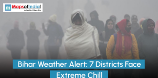 Bihar Weather Alert: 7 Districts Face Extreme Chill People wrapped in shawls and winter clothing walking through dense fog in Bihar, illustrating a weather alert as seven districts face extreme cold and reduced visibility, branded by MapsofIndia.com.